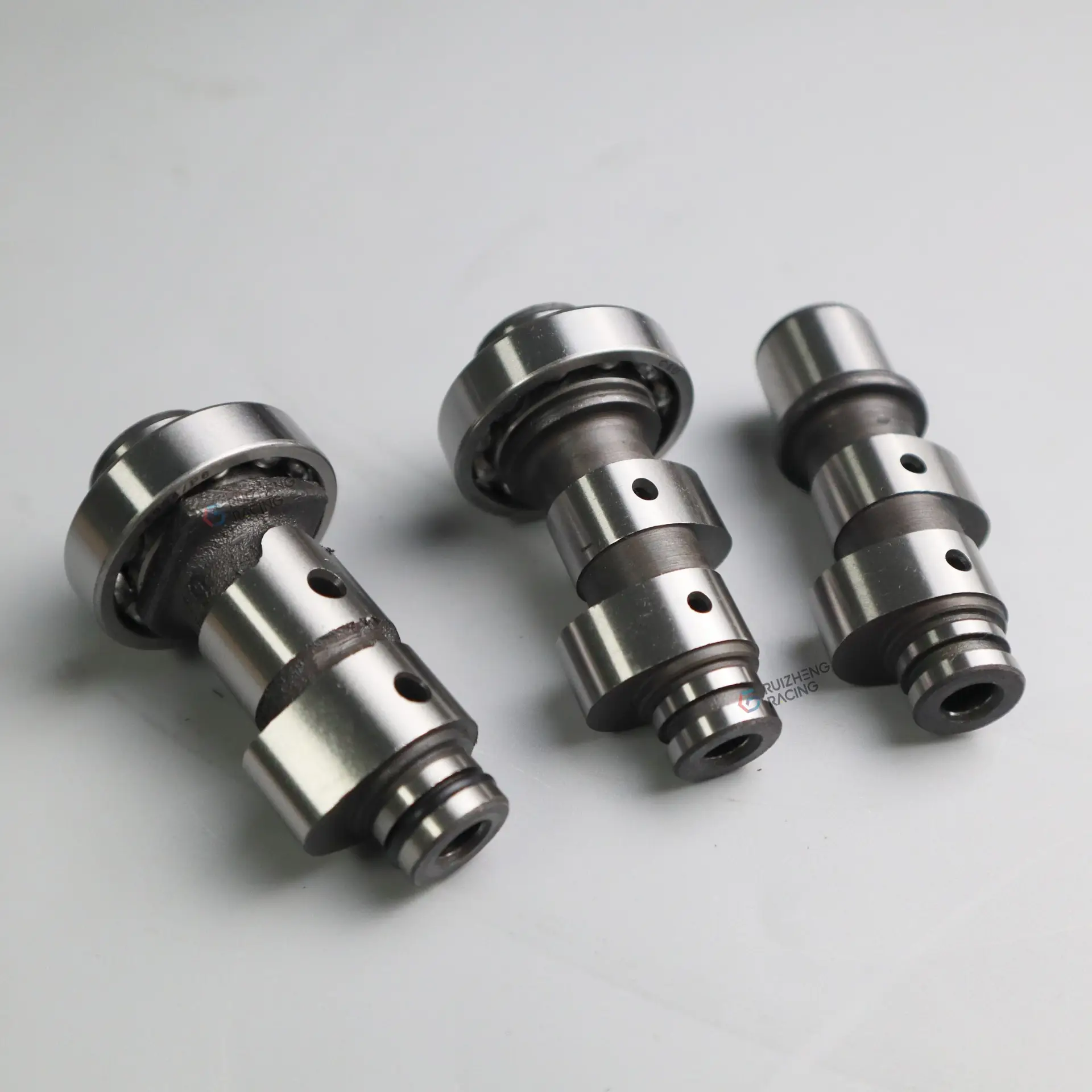Yamaha Mio camshaft set – standard, racing with bearing, racing without bearing, and raw unfinished camshaft